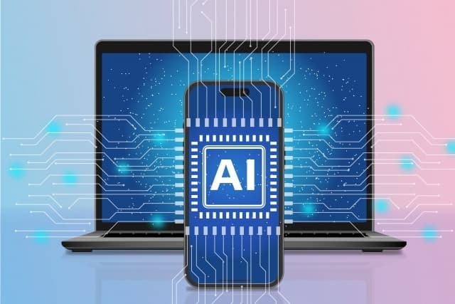 AIと書かれた携帯の背景にパソコン